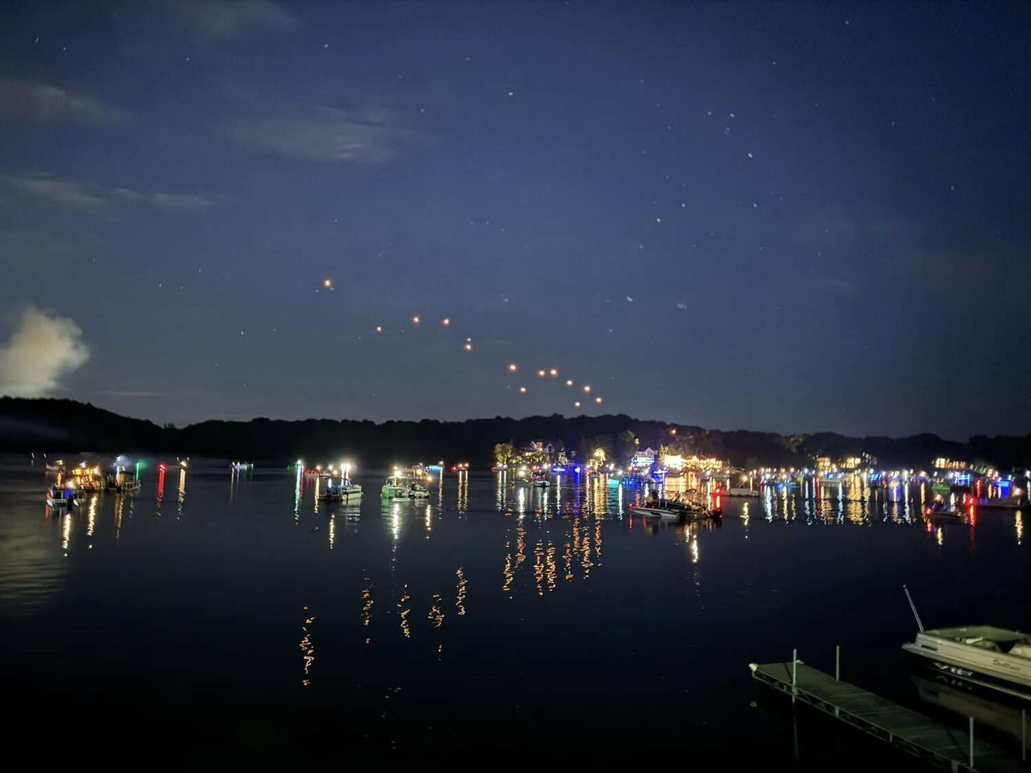 Boats lit on the lake at dusk