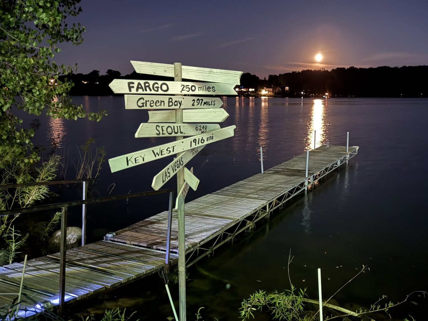 The dock and signpost at moonrise